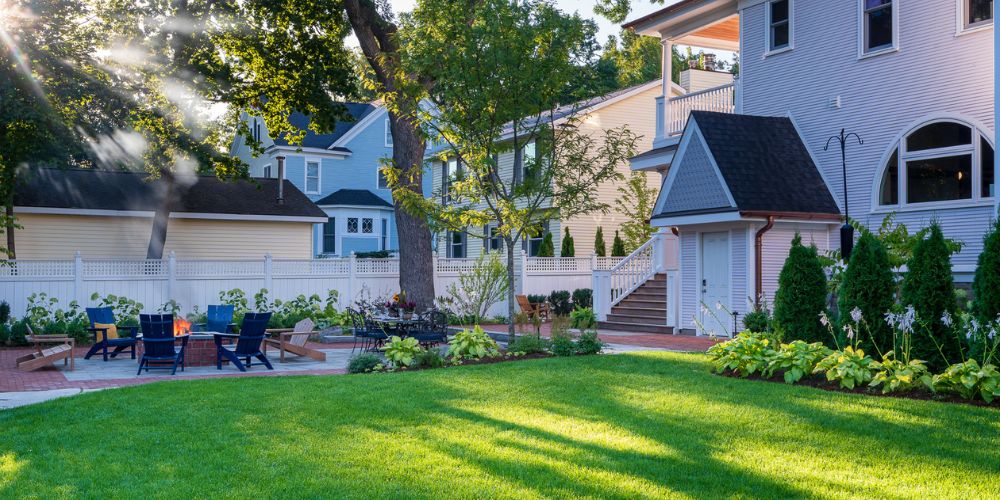 healthy lawn and trees with patio near home