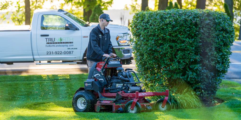 professional lawn mowing company cuts lawn with ride on mower